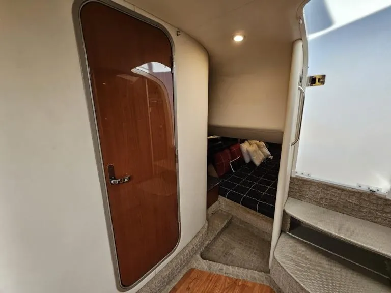 Slide: The Image of Interior cabin of a 2007 Formula 400 Super Sport boat with wooden door and cozy bed. - 23