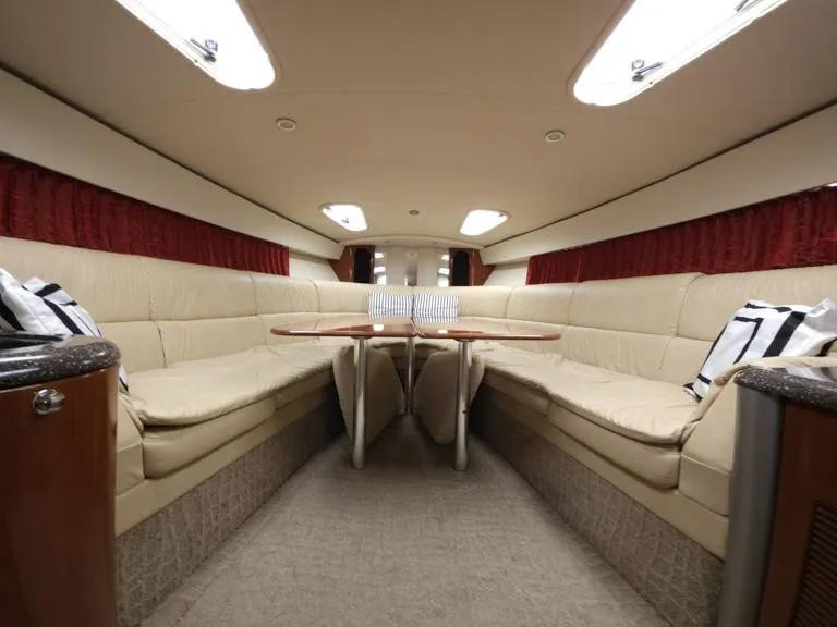 Slide: The Image of Interior of 2007 Formula 400 Super Sport yacht with beige seating and wooden tables. - 25