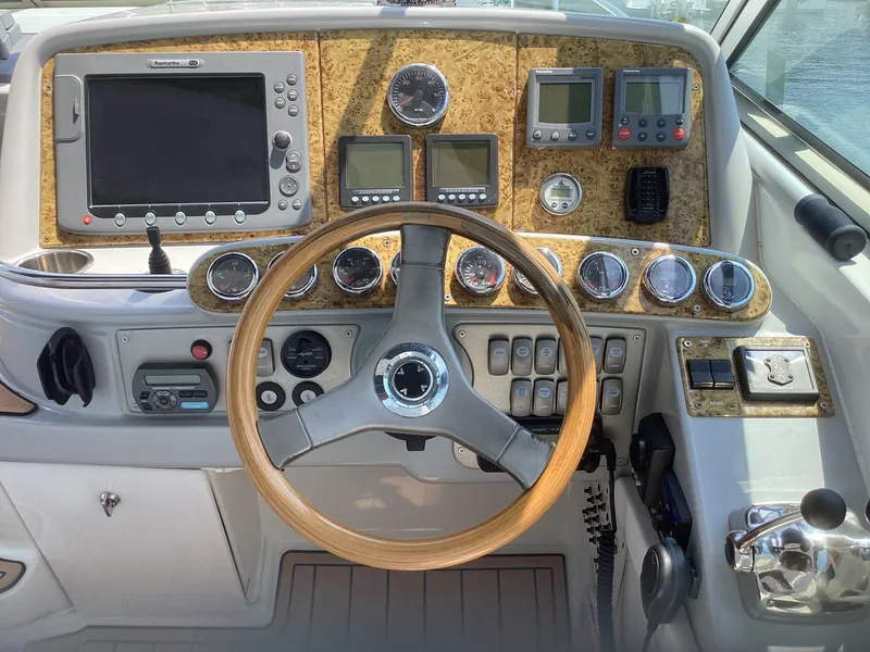 Slide: The Image of 2007 Formula 400 Super Sport boat dashboard with steering wheel and navigation instruments. - 5
