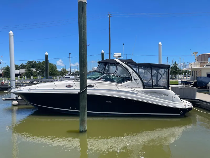 The Image of 2007 Sea Ray 340 Sundancer docked at marina under clear blue sky. - 0