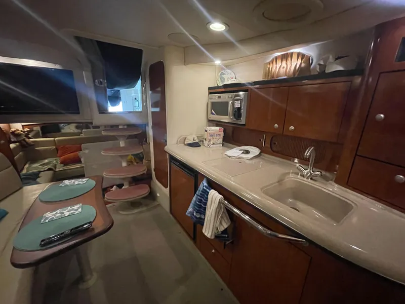 Slide: The Image of Interior of 2007 Sea Ray 340 Sundancer yacht with kitchen and seating area. - 13