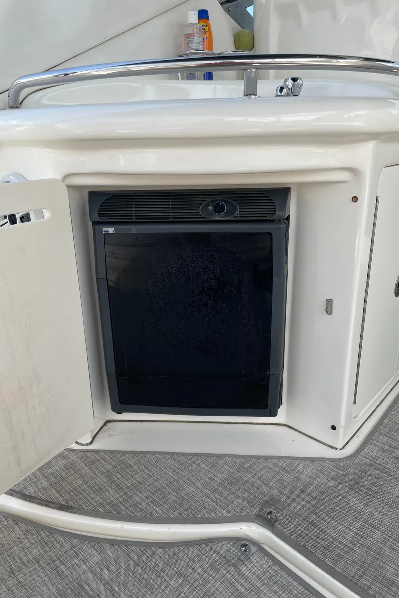 Slide: The Image of 2007 Sea Ray 340 Sundancer mini fridge in cabin with open door. - 20