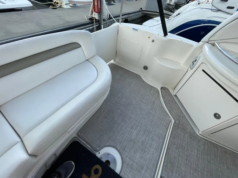 Slide: The Image of 2007 Sea Ray 340 Sundancer boat interior with white seating and carpeted floor. - 21