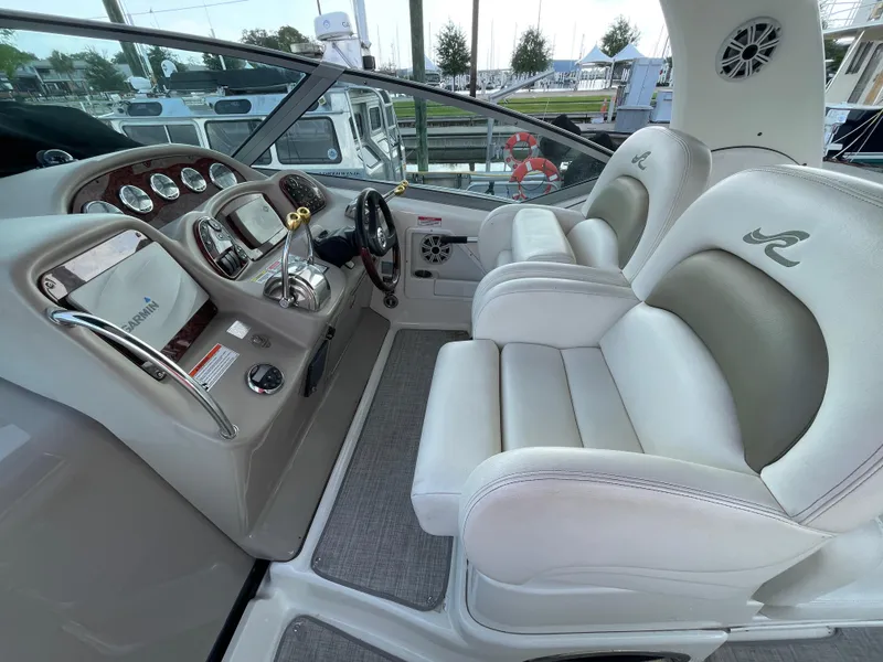 Slide: The Image of 2007 Sea Ray 340 Sundancer helm with dual seats and modern dashboard controls. - 23