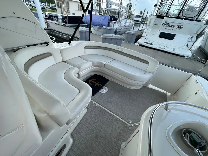 Slide: The Image of 2007 Sea Ray 340 Sundancer boat interior with white seating and marina view. - 25