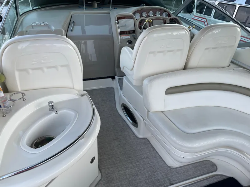 Slide: The Image of 2007 Sea Ray 340 Sundancer cockpit with white seating and helm controls. - 28