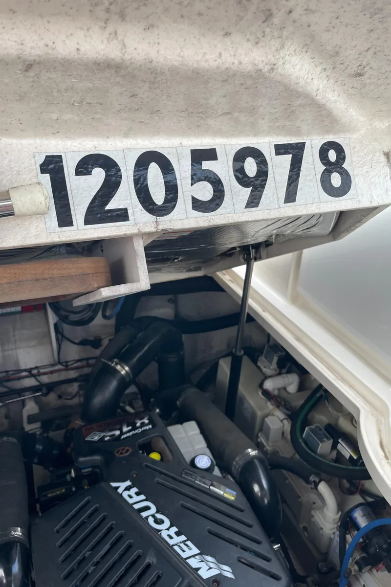 Slide: The Image of Engine compartment of 2007 Sea Ray 340 Sundancer with visible Mercury engine and serial number. - 33