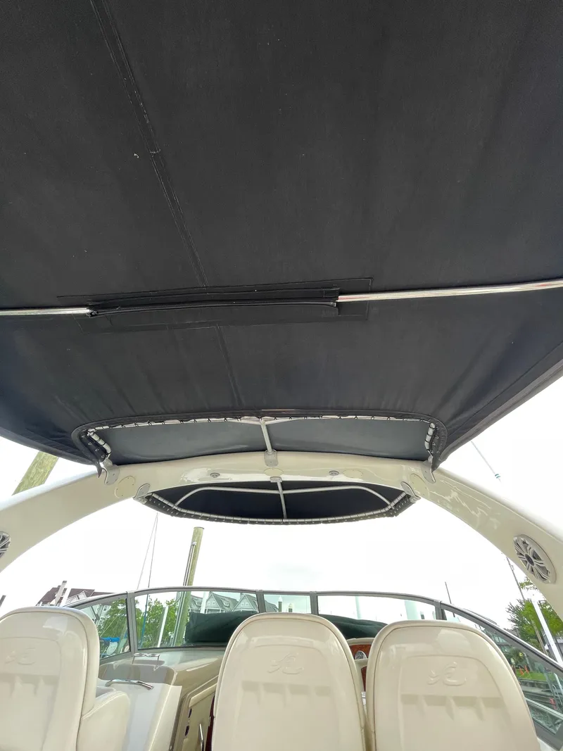 Slide: The Image of 2007 Sea Ray 340 Sundancer boat interior with black canopy and seating. - 34