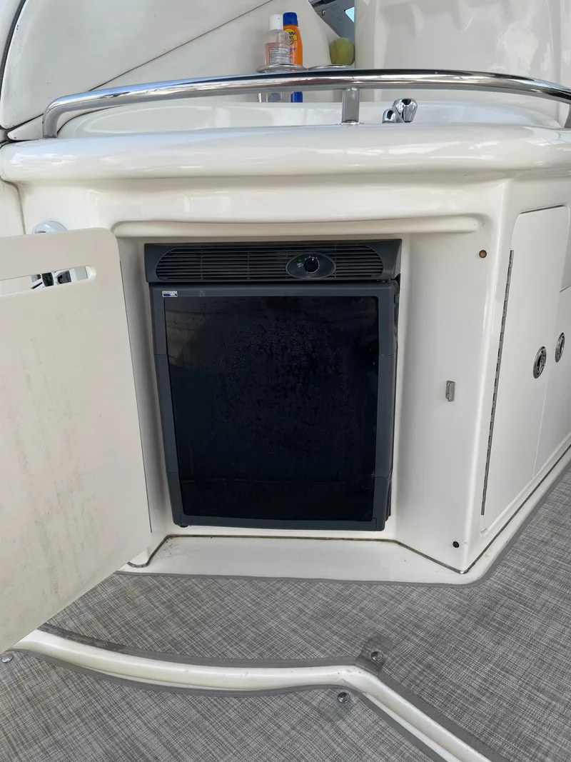 Slide: The Image of 2007 Sea Ray 340 Sundancer boat interior with mini fridge and sink. - 35