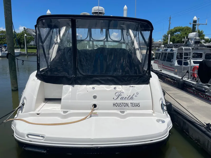 Slide: The Image of 2007 Sea Ray 340 Sundancer docked, rear view with "Faith" and "Houston, Texas" on the stern. - 4