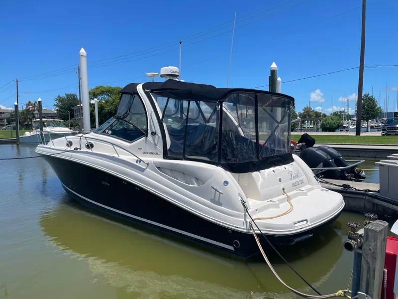 Slide: The Image of 2007 Sea Ray 340 Sundancer boat docked in a marina under clear blue skies. - 5