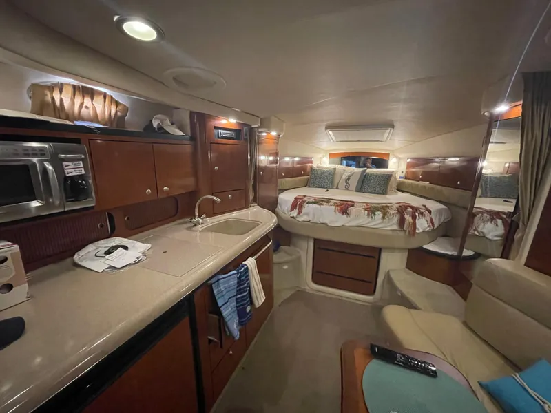 Slide: The Image of Luxurious 2007 Sea Ray 340 Sundancer cabin interior with kitchenette and cozy sleeping area. - 9