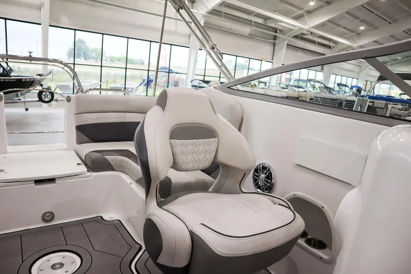 Slide: The Image of 2024 Hurricane SunDeck 2486 OB boat interior with plush seating in showroom. - 10