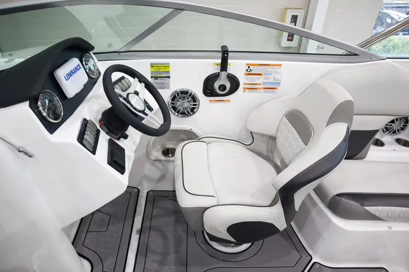 Slide: The Image of 2024 Hurricane SunDeck 2486 OB boat cockpit with steering wheel and captain's chair. - 11