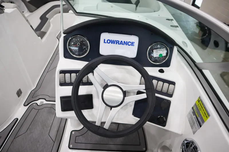 Slide: The Image of 2024 Hurricane SunDeck 2486 OB boat dashboard with Lowrance display and steering wheel. - 12