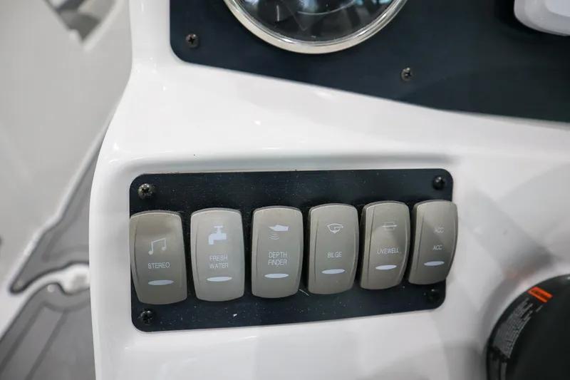 Slide: The Image of Control panel of 2024 Hurricane SunDeck 2486 OB boat with labeled switches. - 13