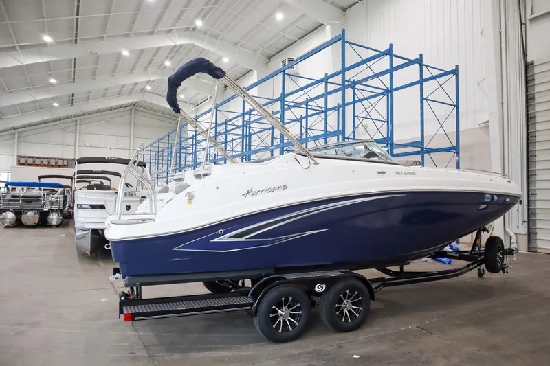 Slide: The Image of 2024 Hurricane SunDeck 2486 OB boat in showroom on trailer. - 2