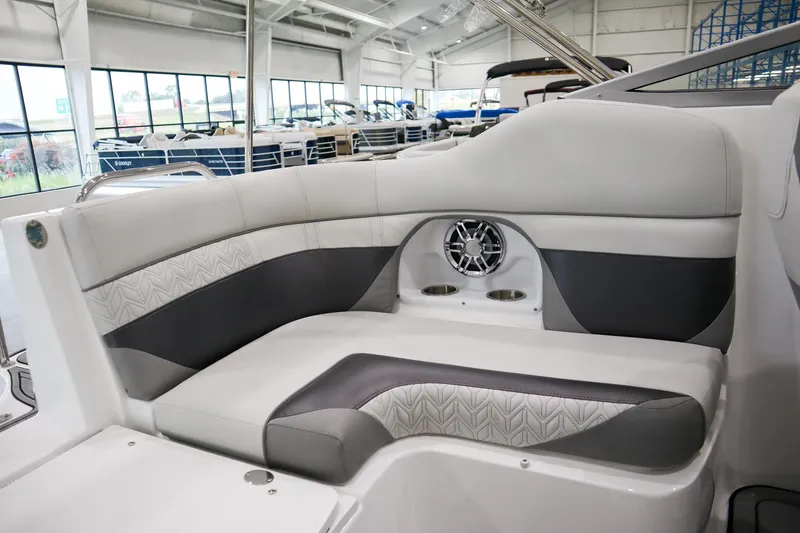 Slide: The Image of 2024 Hurricane SunDeck 2486 OB interior seating with modern design and built-in speaker. - 8