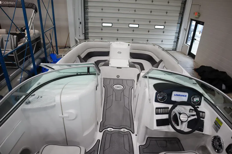 Slide: The Image of 2024 Hurricane SunDeck 2486 OB boat interior with steering console and seating. - 9