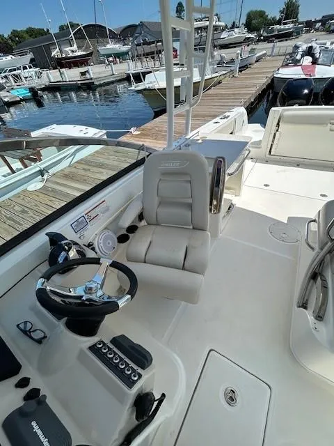Slide: The Image of 2018 Boston Whaler 270 Vantage boat helm station at marina dock. - 10