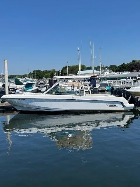 Slide: The Image of 2018 Boston Whaler 270 Vantage docked at a marina on a sunny day. - 13