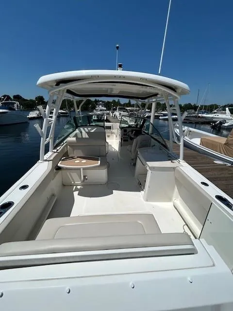 Slide: The Image of 2018 Boston Whaler 270 Vantage boat docked at marina on a sunny day. - 5