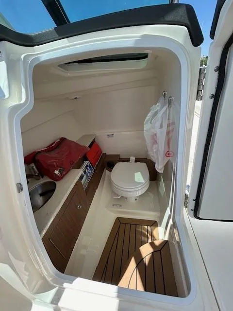 Slide: The Image of 2018 Boston Whaler 270 Vantage boat interior with toilet and sink. - 8