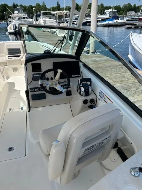 Slide: The Image of 2018 Boston Whaler 270 Vantage boat cockpit with steering wheel and control panel. - 9