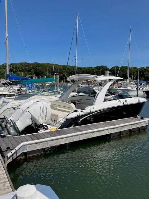 The Image of 2021 Cobalt 30SC Outboard boat docked at a marina. - 0