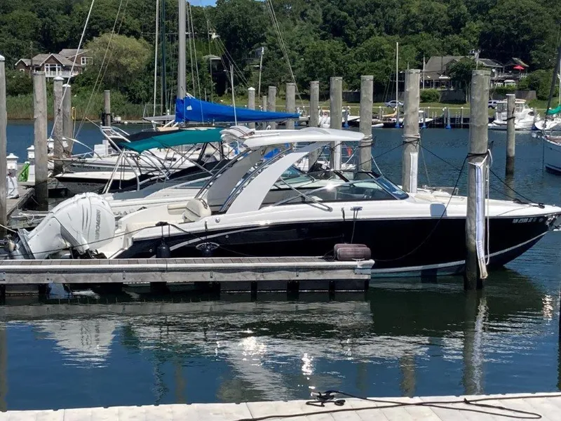 Slide: The Image of 2021 Cobalt 30SC Outboard boat docked at a marina. - 1