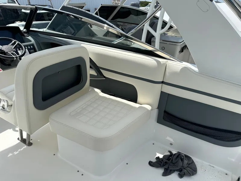 Slide: The Image of 2021 Cobalt 30SC Outboard boat interior with white and gray seating. - 14