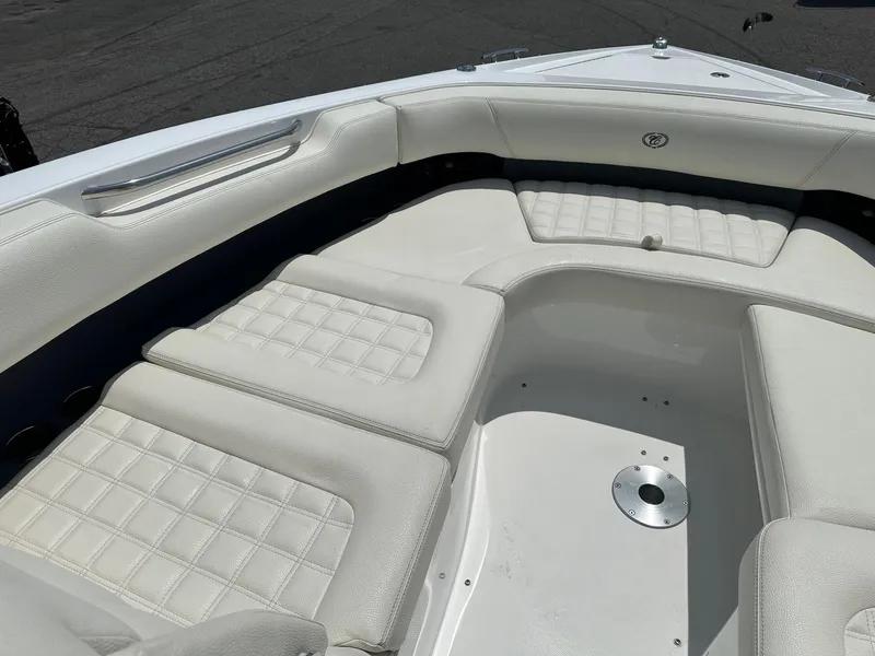 Slide: The Image of 2021 Cobalt 30SC Outboard boat with white cushioned seating area. - 21