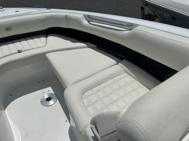 Slide: The Image of 2021 Cobalt 30SC Outboard boat with white cushioned seating. - 22