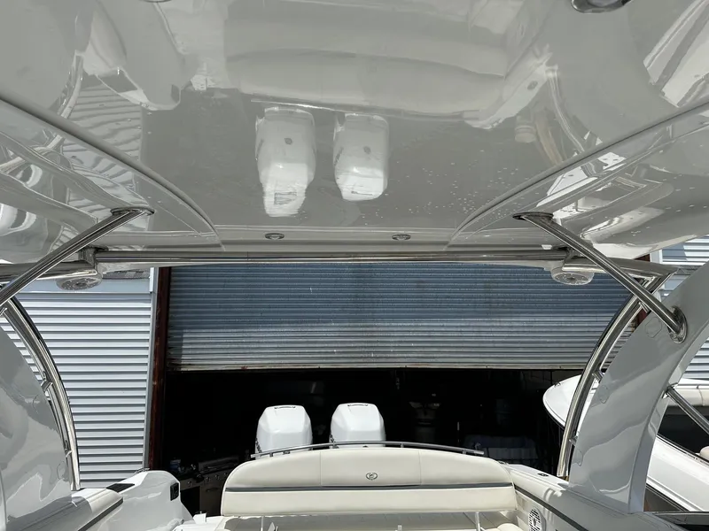 Slide: The Image of 2021 Cobalt 30SC Outboard boat with dual engines in a storage facility. - 25
