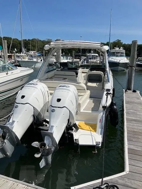 Slide: The Image of 2021 Cobalt 30SC Outboard boat docked at a marina. - 28