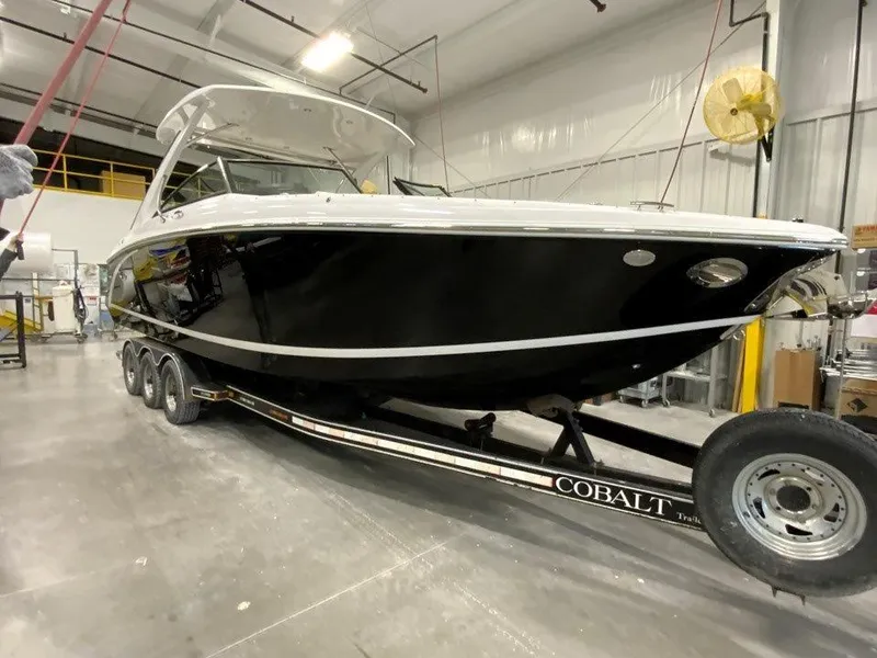 Slide: The Image of 2021 Cobalt 30SC Outboard boat on a trailer in a warehouse. - 3
