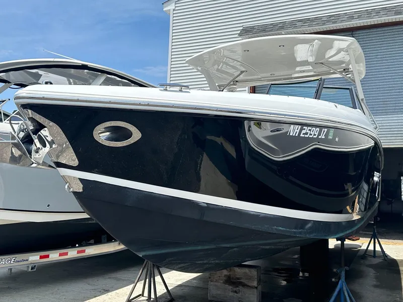 Slide: The Image of 2021 Cobalt 30SC Outboard boat in a marina, side view. - 4
