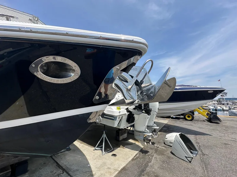 Slide: The Image of 2021 Cobalt 30SC Outboard boat at marina, showcasing propeller and hull. - 6