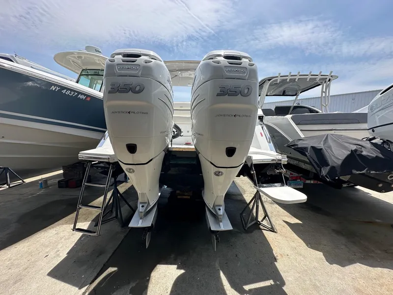 Slide: The Image of 2021 Cobalt 30SC Outboard with twin 350 engines docked at marina. - 8