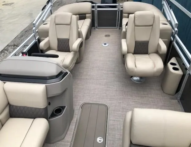 Slide: The Image of 2024 Sun Tracker Party Barge 22 XP3 interior with beige seating and spacious layout. - 16
