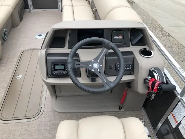 Slide: The Image of 2024 Sun Tracker Party Barge 22 XP3 helm with steering wheel and control panel. - 19