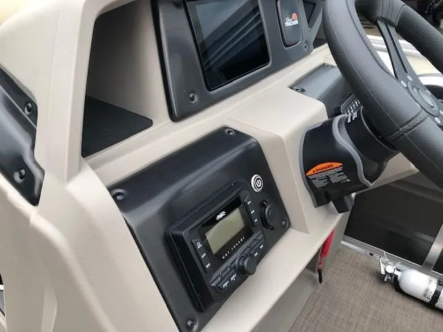 Slide: The Image of 2024 Sun Tracker Party Barge 22 XP3 dashboard with steering wheel and control panel. - 21