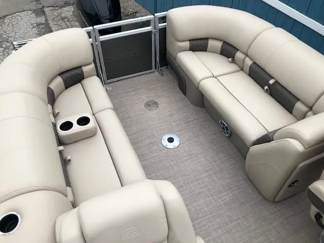 Slide: The Image of 2024 Sun Tracker Party Barge 22 XP3 interior with beige seating and cup holders. - 24