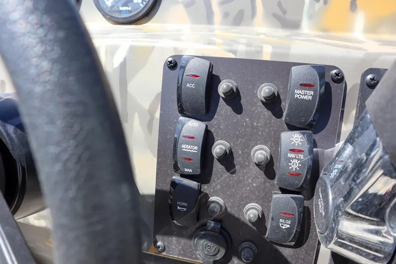 Slide: The Image of Control panel of 2024 War Eagle 2170 Blackhawk boat with various switches. - 14