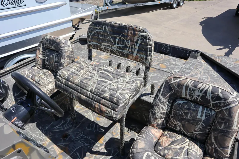 Slide: The Image of 2024 War Eagle 2170 Blackhawk boat interior with camo seats and steering wheel. - 15