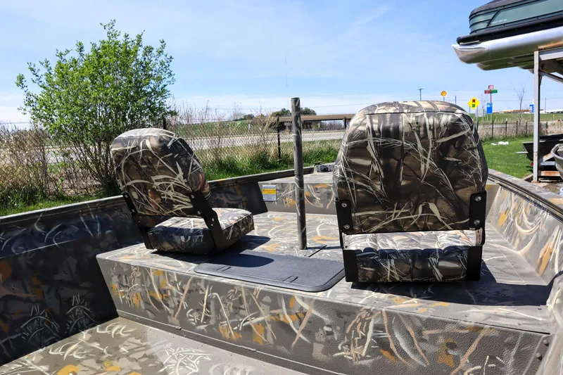 Slide: The Image of 2024 War Eagle 2170 Blackhawk boat with camo seats and interior. - 19