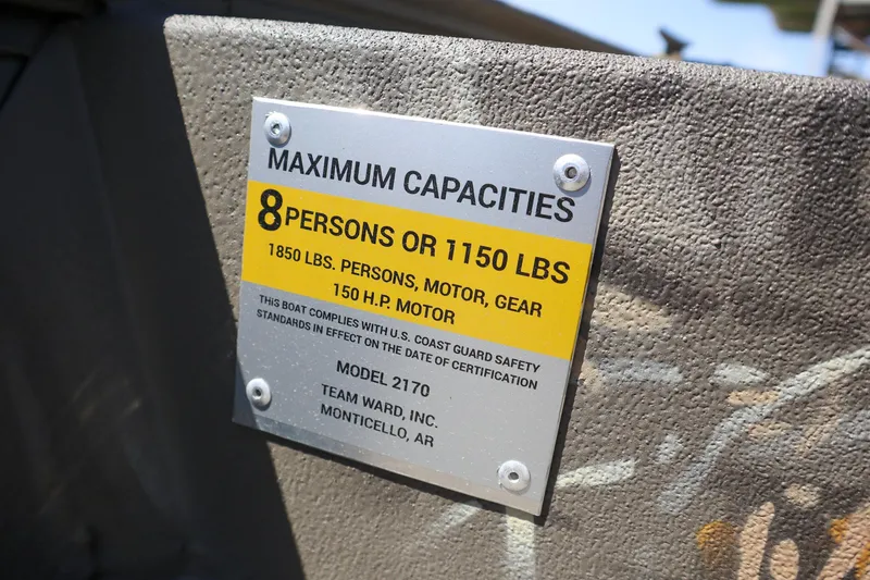 Slide: The Image of 2024 War Eagle 2170 Blackhawk capacity plate, 8 persons or 1150 lbs, 150 HP motor. - 21