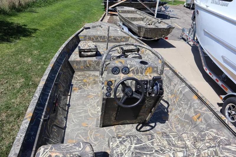 Slide: The Image of 2024 War Eagle 2170 Blackhawk boat with camouflage interior and steering console. - 6