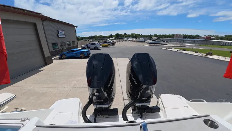 Slide: The Image of Two powerful outboard engines are mounted on the stern of a boat parked on a lot. - 5
