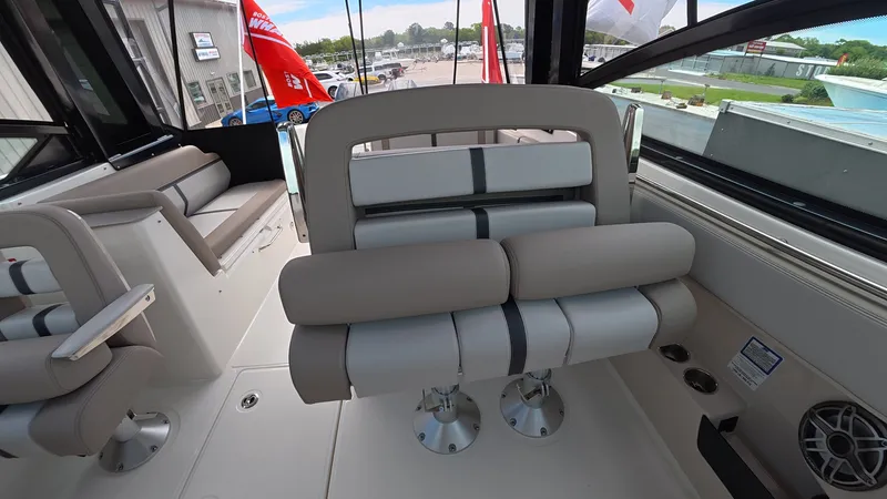 Slide: The Image of The image shows the interior of a 2025 Boston Whaler 330 Vantage with beige seating. - 19
